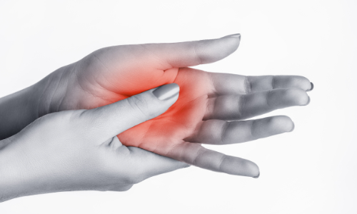 cropped view of a thumb pressing against the palm of a hand