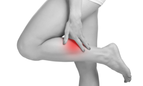 cropped view of a woman touching her leg